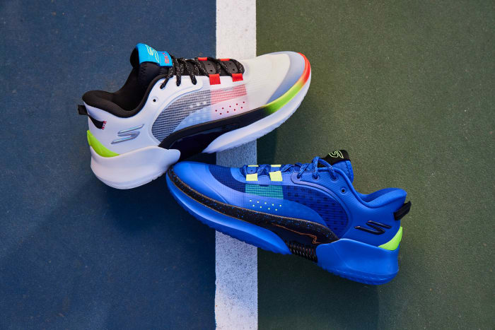 White and blue Skechers basketball shoes on an outdoor court.